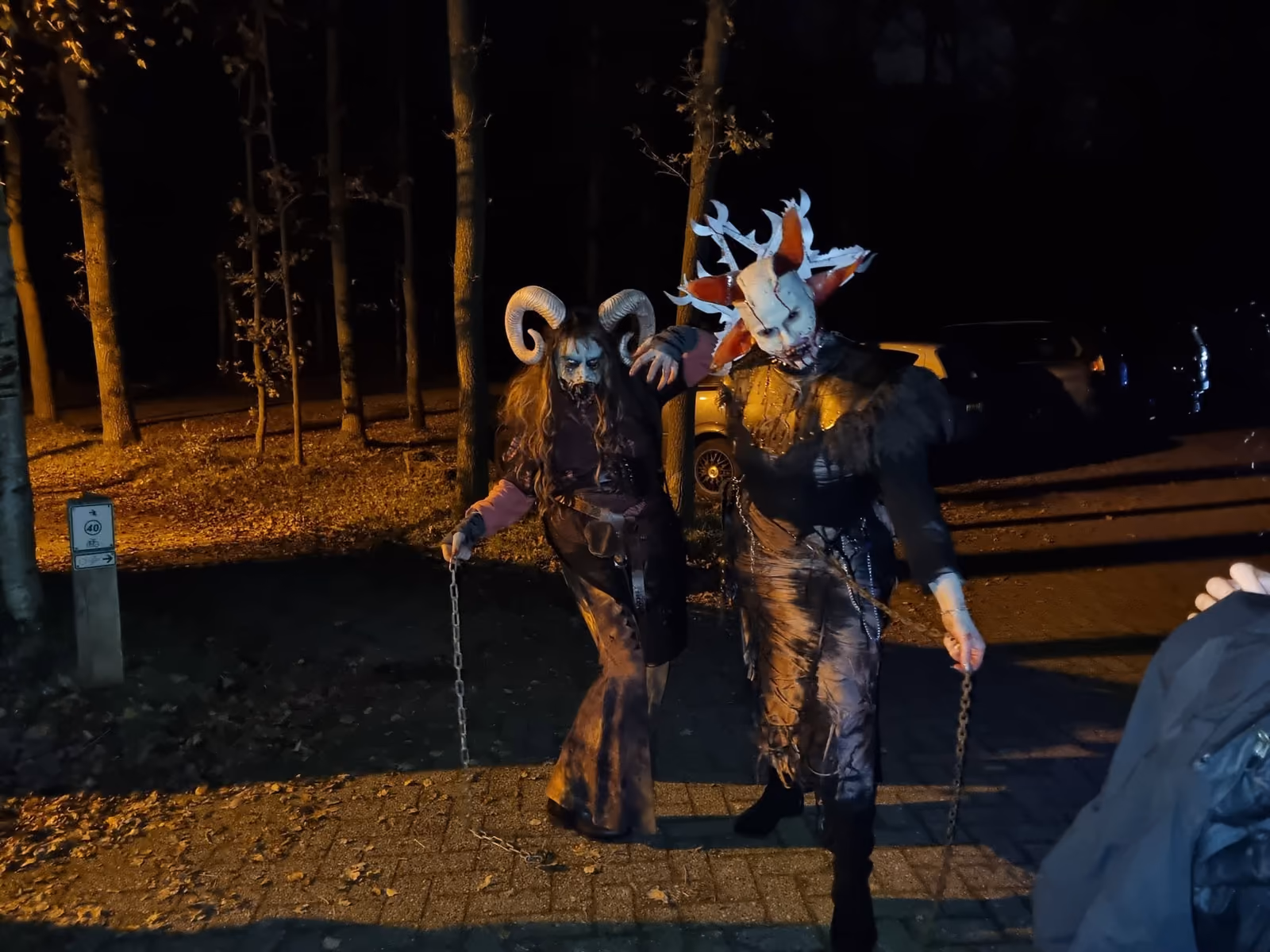 Gemaskerde figuren op een donker pad tijdens Horror Tocht Enschede